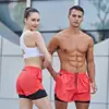 Pantalones cortos transpirables para entrenamiento de comercio exterior transfronterizo para hombres y mujeres, con forro anti-exposición, diseño de dos piezas falsas, adecuados para correr y deportes al aire libre