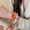 Pulsera redonda de cuentas con carcasa de resina degradada, sensación de lujo ligero de alta gama, accesorio de mano con diseño personalizado al por mayor