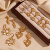 Pendientes de temperamento y personalidad INS de Europa y Estados Unidos, acero inoxidable chapado en oro de 18 quilates, estrella de mar, costura de flor, amor, cesta colgante en espiral