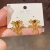 Otoño e Invierno Nuevo Estilo Pendientes Metálicos de Fuegos Artificiales con Piedra Ojo de Tigre Personalizados Lujo Ligero Estilo Fresco Pendientes Versátiles Venta al por Mayor