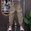 Nueva colección de primavera y otoño: Pantalones recubiertos contra el viento, modernos, versátiles y cómodos para hombre, adecuados para deportes, actividades al aire libre y uso casual.; diseño holgado de pierna cónica