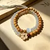 Pulseira de Contas Budistas de Sândalo Dourado com Duplo Círculo, Estilo Étnico Pulseira de Madeira de Sândalo com Borla Multi-Círculo Cultural e Criativa Atacado
