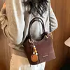 Bolso de mano para mujer estilo coreano transfronterizo 2026 nuevo bolso versátil bolso cubo retro simple bolso de hombro cruzado