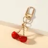 Colgante Llavero Cereza Transfronterizo Europeo y Americano, Llavero Marguerita Mariposa Pequeña, Encanto Creativo Realista Bolsa de Frutas
