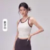 Top de yoga para mujer con cintura plisada, copas fijas que se mantienen en su lugar, elegante diseño de bloques de color y espalda cruzada