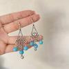 Pendientes colgantes de piedra de pino de estilo nacional retro bohemio europeo y americano transfronterizos, pendientes con borlas huecas, venta directa de fábrica