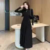 Vestido Tricô Francês 2026 Feminino Gola Meia-Alta Mangas Bufantes Cintura Marcada Linha A Base Longa Vestido de Lã