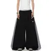 Pantalones de chándal deportivos de retazos a rayas para mujer y hombre, pantalones de baile holgados de pierna ancha para otoño, pantalones versátiles y adelgazantes de largo completo