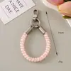 Estilo Ins Corda de telefone floral elástica curta Alça de pulso para celular Pingente versátil para bolsa Corrente de telefone anti-perda Pingente fofo