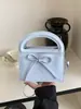 Bolsa de mão simples com laço transfronteiriça para mulheres, nova bolsa elegante e versátil de alta qualidade para ombro e transversal 2026