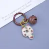 Clip de resorte Campanita Llavero de Gato Dibujo animado lindo Gato Donut Mochila Funda para auriculares Colgante de moda versátil