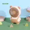 Nuevo ventilador de mano de dibujos animados portátil para exteriores con carga ventilador pequeño para estudiantes niños ventilador eléctrico venta al por mayor de fábrica