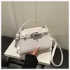 Bolso pequeño elegante de alta gama para mujer 2026 nuevo bolso cruzado versátil bolso de mano súper popular de moda con cierre de candado bolso pequeño de mano