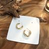 Agente de compras de Dongdaemun en Corea del Sur, pendientes del mismo estilo para mujer, pendientes de metal sinuoso mate con textura combinable, sencillos y elegantes.