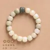 Gradiente de intemperie Bodhi DIY verde Yin cuero Bodhi tallado ola de la fortuna gato lindo borla pulsera simple