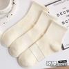 Calcetines blancos y negros mujer otoño e invierno algodón altos banda de goma calcetines de tubo mujer color sólido tendencia ins ocio calcetines deportivos al por mayor