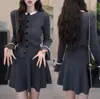 Conjunto de dos piezas de estilo francés de lujo ligero nuevo para mujer 2026: suéter, cárdigan de punto, chaqueta y falda de estilo japonés y coreano