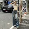 Jeans Americano Retrô de Cintura Baixa Flare para Mulheres 2025 Novo Design de Verão Sexy Emagrecedor Calças Flare de Perna Larga