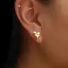Pendientes de corazón cruzado Europa y Estados Unidos combinación de colores oro y plata joyería para orejas de estilo mecánico de lujo ligero de alta gama con forma de corazón de amor