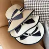 Sombrero femenino verano estilo coreano lazo grande sombrero de paja de playa viaje vacaciones protección solar sombrero para el sol sombrero de paja tejido estilo Chanel tipo cubo