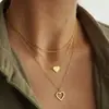 Collar de moda multicapa transfronterizo europeo y americano más vendido, collar con colgante de doble corazón elegante y único para mujer, venta al por mayor