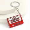 Llavero retro transfronterizo con temática musical que presenta discos de vinilo, casetes y tocadiscos, con un dije de acrílico para llavero