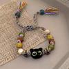 Pulseira de cabeça de gato de olhos grandes super fofo dos desenhos animados para mulheres Design de nicho Pulseira frisada colorida Pulseira tecida à mão colorida