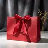 Bolsa de papel con lazo, bolsa estampada para ropa, bolsa de regalo, bolsa de compras, bolsa de embalaje, bolsa de cosméticos, color para comercio exterior