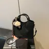 Bolso de mano casual simple de nicho estilo coreano, bolso tote pequeño para mujer, nuevo bolso de moda 2026 para ir al trabajo, al hombro y cruzado