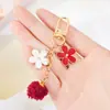 Al por mayor Nuevo Estilo Personalizado Llavero de Flor Pompones Estilo Japonés Colgante de Aleación con Goteo de Aceite para Coche y Bolsa para Parejas