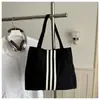 Bolso tote de lona de gran capacidad estilo casual coreano 2026 para mujer, nuevo bolso de mano de moda para estudiantes, adecuado para la escuela y el trabajo