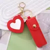 Llavero con caja creativa de cuero PU para guardar labiales, con espejo de maquillaje en forma de corazón y colgante de cubierta protectora para labiales, para Amazon transfronterizo