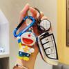 Llavero auténtico de Doraemon con diseño de experto deportivo, colgante creativo de mochila escolar con dibujo de coche, regalo pequeño para pareja, venta al por mayor