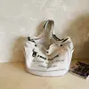 Bolsa de Lona para Mulheres 2026 Novo Estilo Transfronteiriço Bolsa Tote de Grande Capacidade com Letras Estampadas Casual para Trabalho Bolsa de Ombro Transversal