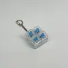 Llavero de botón de PC de alta transparencia para descompresión 123456 llaves nueve llaves cuadrícula Tianzi probador de interruptores colgante luminoso transfronterizo en stock