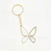 Suministro y Ventas del Fabricante Llavero con Borla de Mariposa Dorada y Pompón Colgante para Bolso de Mujer Adorno Colgante con Exquisita Decoración de Flor