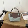 Bolso de mano cuadrado pequeño estilo fresco y dulce al por mayor para mujer, nuevo modelo de verano 2026, bolso de hombro con bloques de color, bolso cruzado de moda