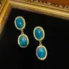 Estilo Occidental Chapado en Cobre Antiguo con Oro de 18 Quilates para Crear un Color Dorado Vintage, Combinado con Pendientes Colgantes Dobles Redondos Incrustados con Degradado de Color Tinta