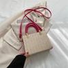 Bolso tejido de paja para mujer, primavera 2023, nuevo bolso de mano informal de moda, bolso de hombro tejido de gran capacidad de color sólido.