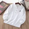 Camisa POLO infantil 2025 primavera e outono meninos e meninas rua frita cor sólida bordado camisa de base bebê gola polo manga longa T