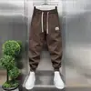 Novidade de Outono Calça de Moletom Esportiva Bordada com Letras para Homem Moda Tendência Cintura Elástica Jogger Harem Slim Casual