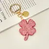Nova Chaveiro Trevo de Quatro Folhas Cheio de Diamantes de Argila de Cristal Exquisito Pingente de Carro com Pedras Strass Embutidas Bolsa de Luxo Leve