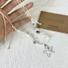 Collar trenzado con cuentas de estrella de mar y conchas estilo vacación en la playa para mujer, moderno y de alta gama, accesorio de cadena para la clavícula