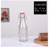 Botella de vidrio transparente con cierre a presión, redonda y cuadrada, para zumo de fruta, vino, licor de elaboración propia, vacía.