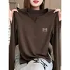 Camiseta de manga larga con botones de alta gama para mujer, diseño de otoño 2026, top de moda nicho elegante y versátil