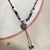 Collar con colgante de campana de mariposa de cerámica de estilo étnico retro para mujer, diseño nuevo y moderno, cadena larga para suéter, accesorios