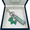 Lindo caballito moderno versátil top de cuero de vaca colgante de llavero de metal para hombres y mujeres, estilo pareja versión coreana llavero