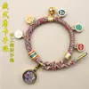 Pulsera tejida a mano estilo Tíbet con Cinco Deidades de la Riqueza, Pulsera Thangka, Colgante Ojo del Dharma del Dios de la Riqueza, Pulsera de Hilo Rojo con Cascabel