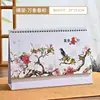 Calendário de Mesa Elevado 2027 Personalizado Novo Calendário de Mesa com Suporte em Papel Pérola Hot Stamping Publicidade Ano do Carneiro Calendário de Mesa Presente Atacado