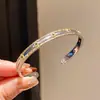Pulseira Aberta Formato de Olho com Gotejamento de Óleo em Aço Inoxidável de Luxo Leve Transfronteiriça Europeia e Americana, Pulseira de Alta Qualidade, Acessório de Mão Estiloso e Moderno